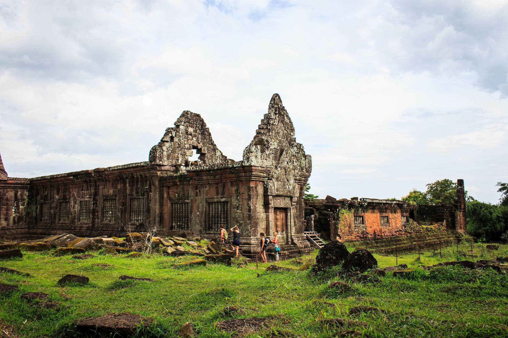 Ancient Wat Phu temple in Champasak on a scenic Champasak Travel banner by Legend Travel Group.